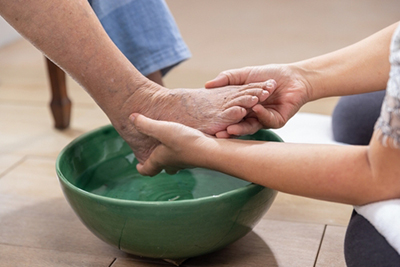 Clean diabetic foot being carefully dried to prevent infection