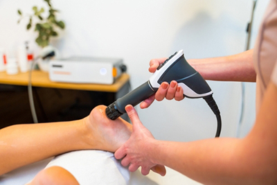 Heel pain treatment with shock wave therapy by foot specialist